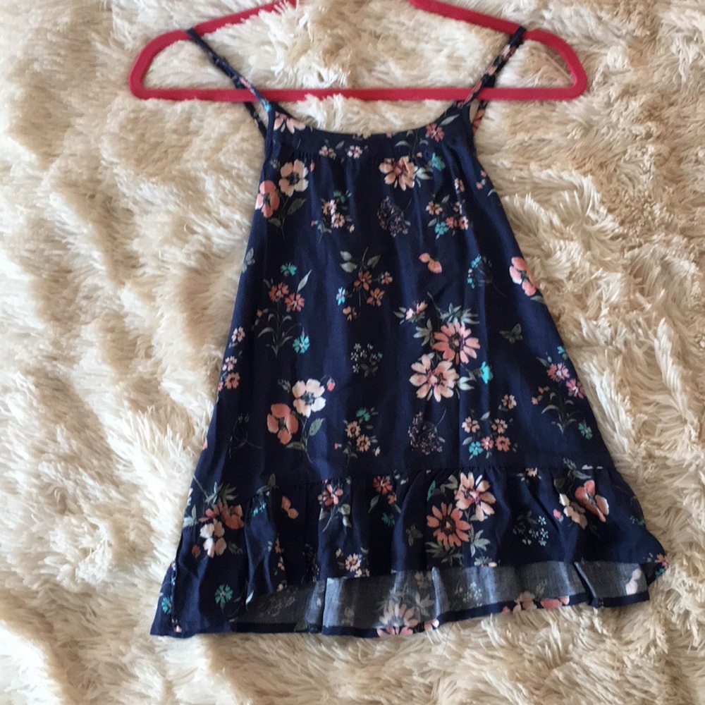 Blue blouse with cross straps in back.